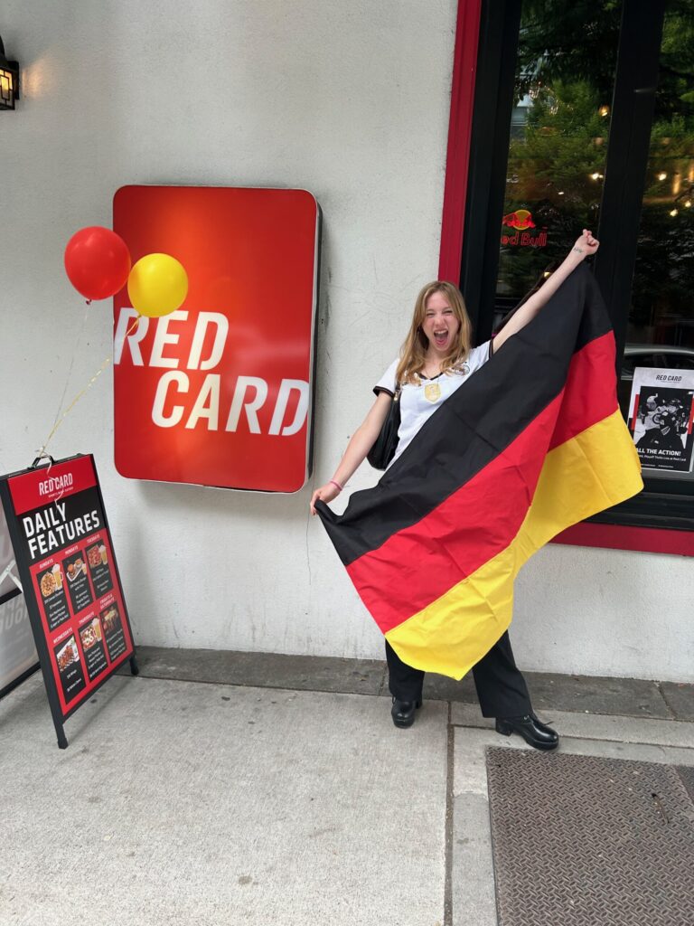 Sophia holding a German flag at the Red Card!