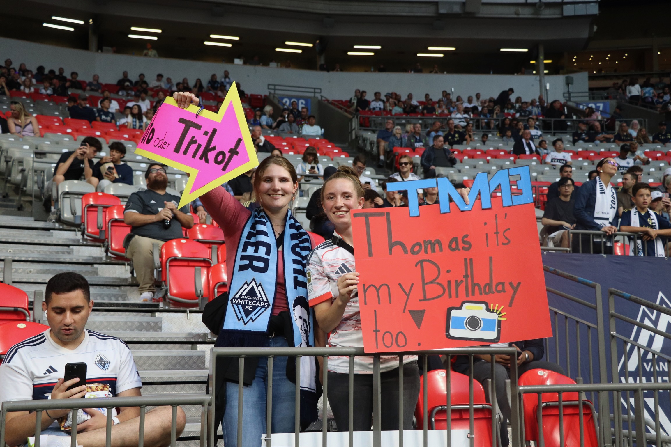 Fans holding Happy Birthday Signs.