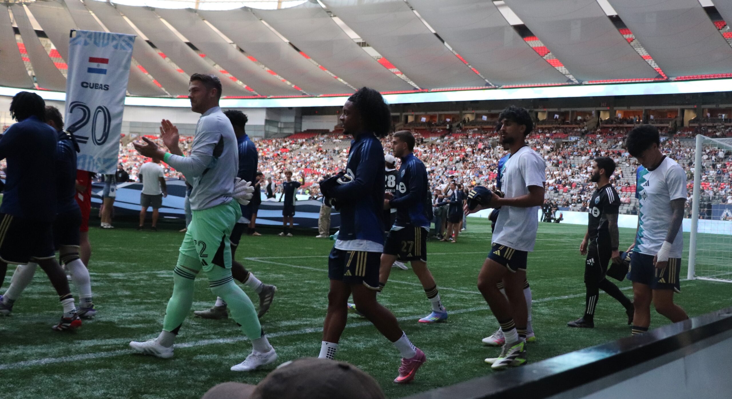 The team walking on the field.