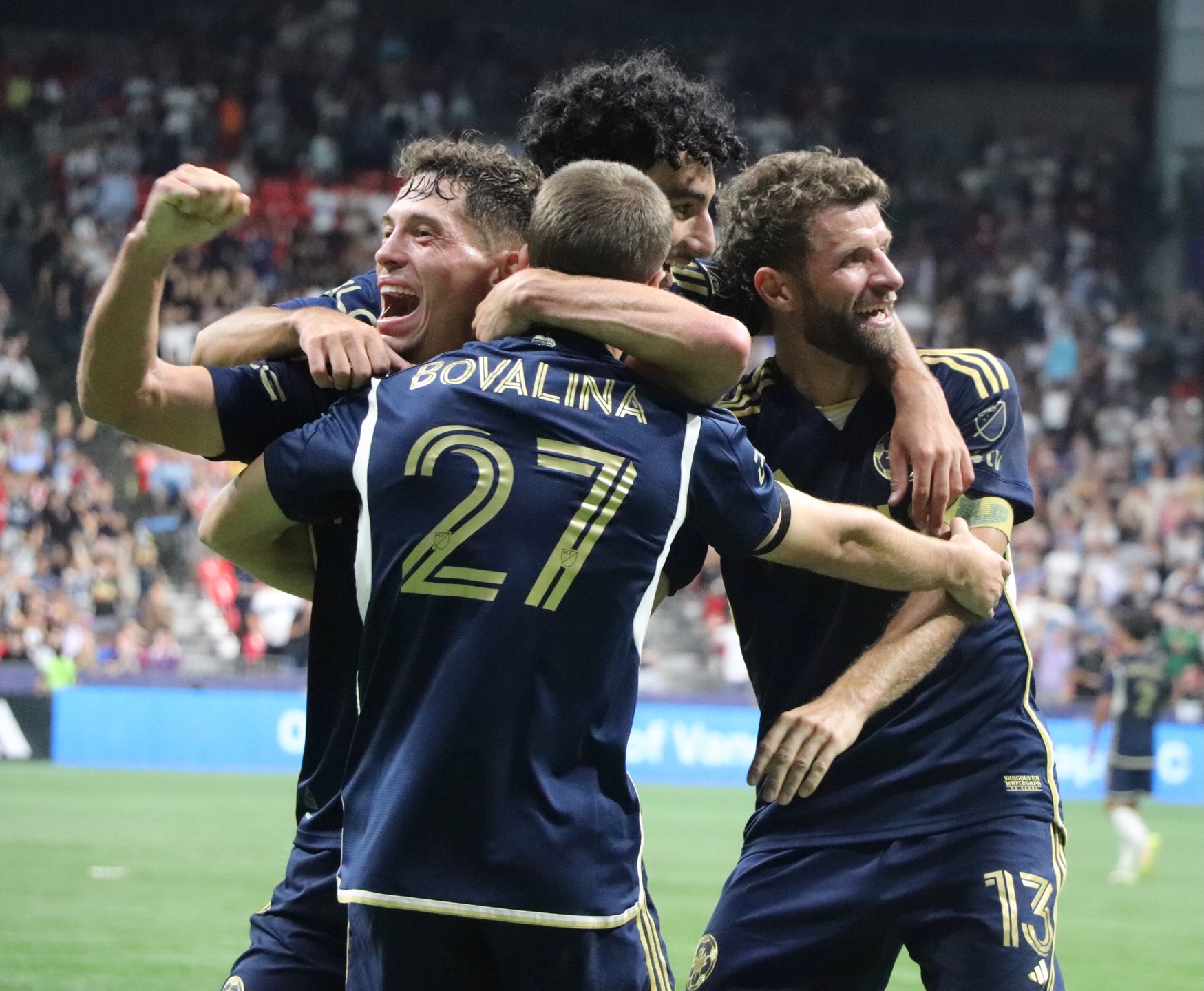 Sebastian Berhalter and Thomas Müller in a cheering huddle.