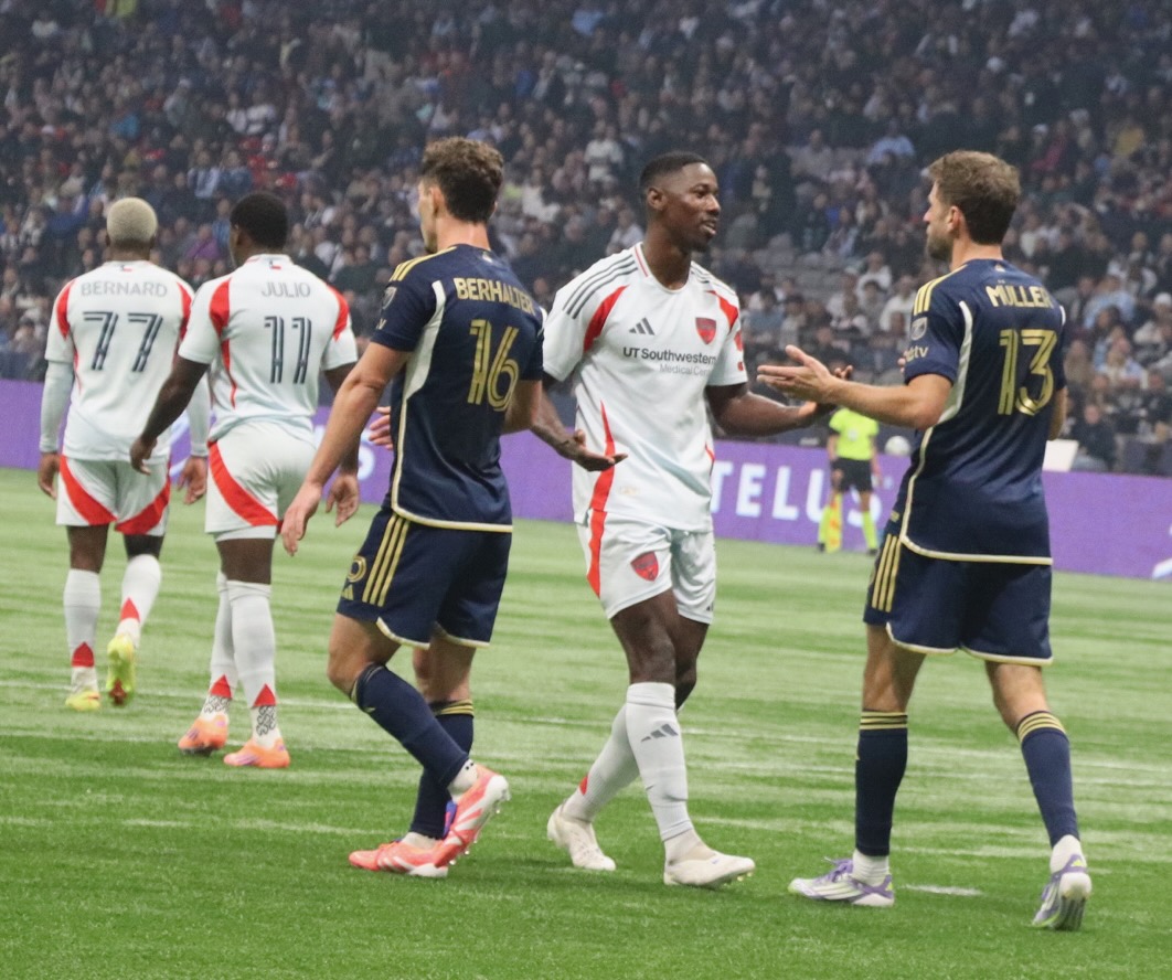 Thomas talking to a Dallas soccer player.