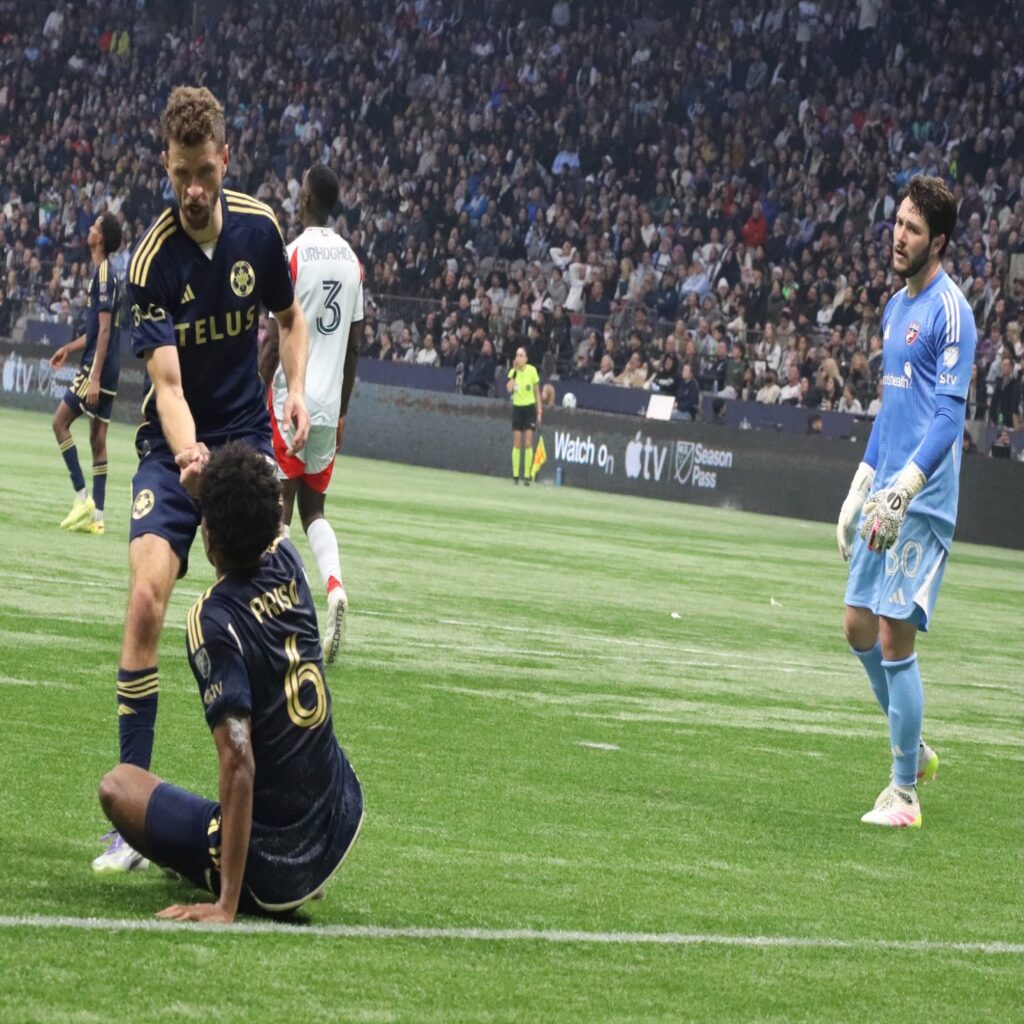 Müller helping Priso up.