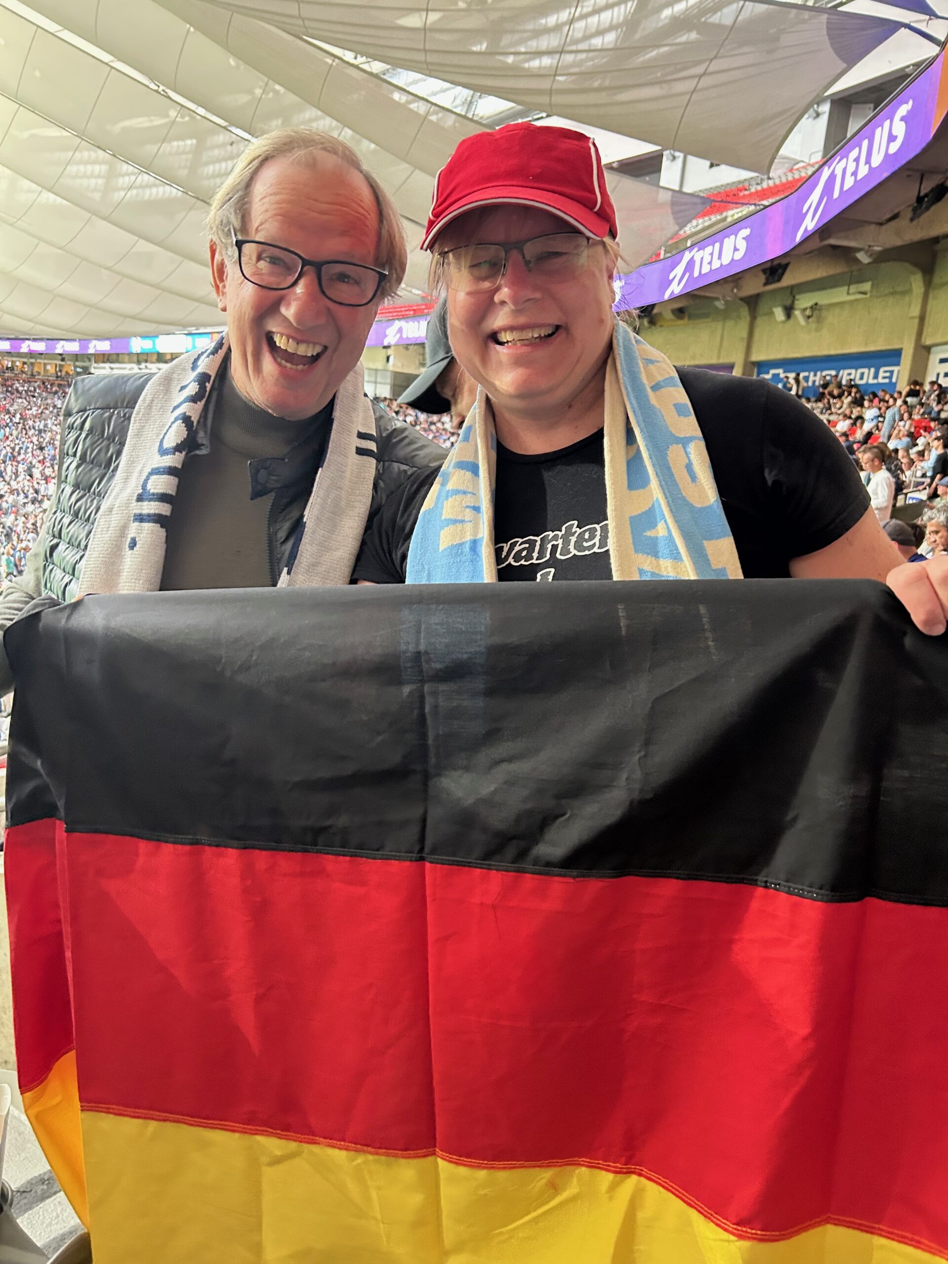 Ozzie and Elke holding German flag at Whitecaps