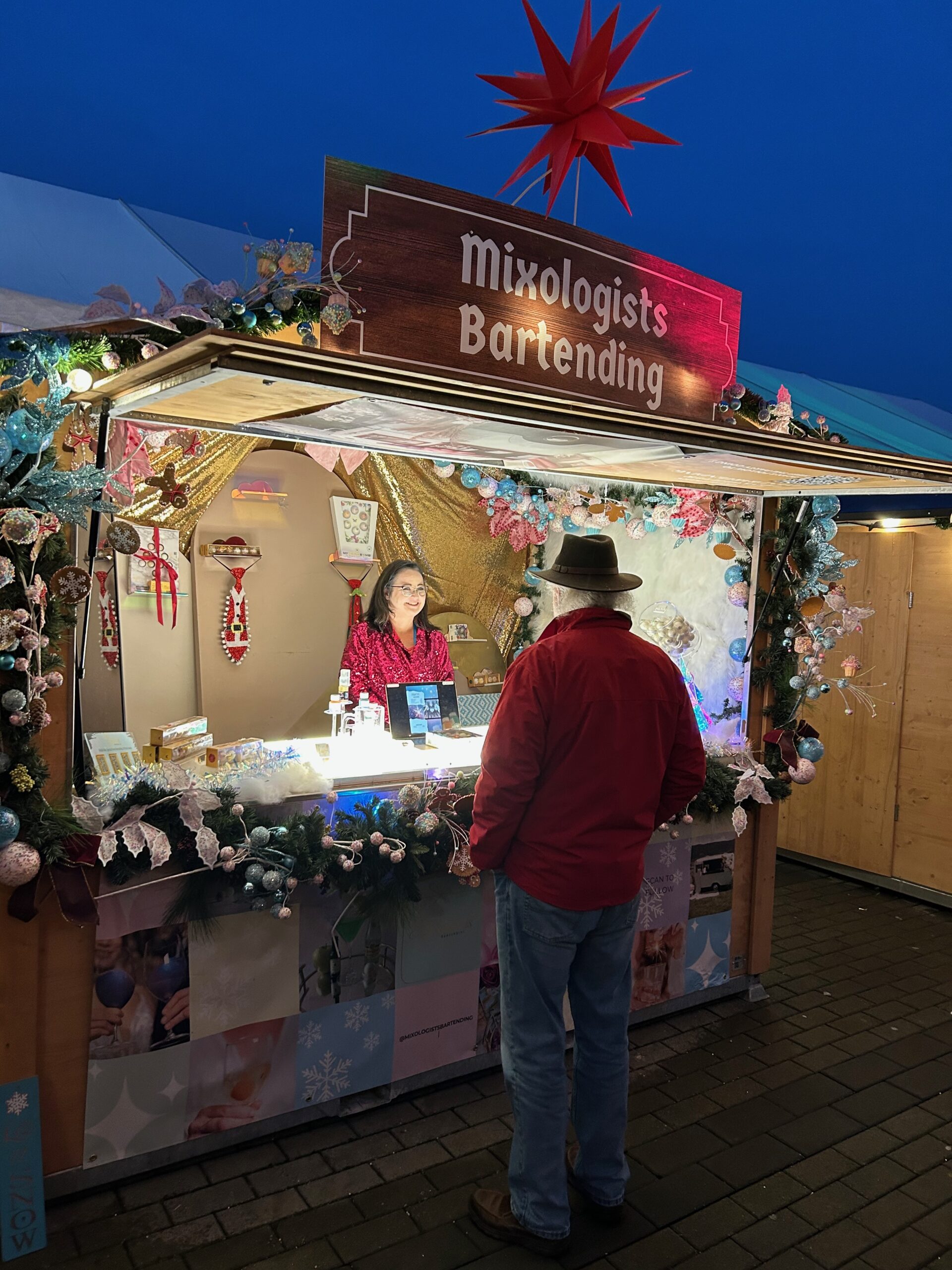 Malte Kluetz, the owner and founder of the Vancouver Christmas Market talking to the Mixologists Bartending.