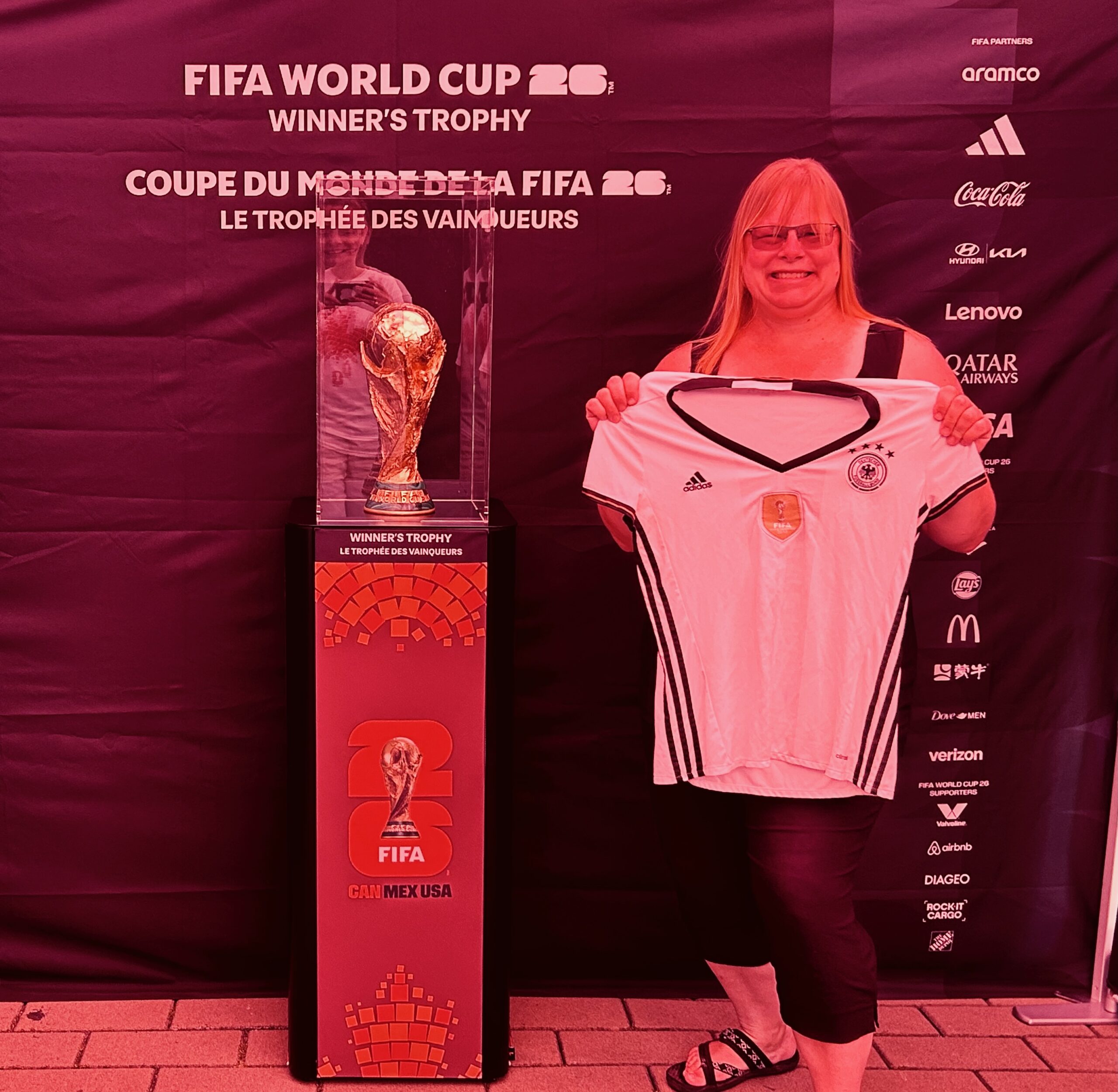 Holding Team Germany Jersey (Die Mannschaft) from 2014 next to the actual FIFA Trophy.